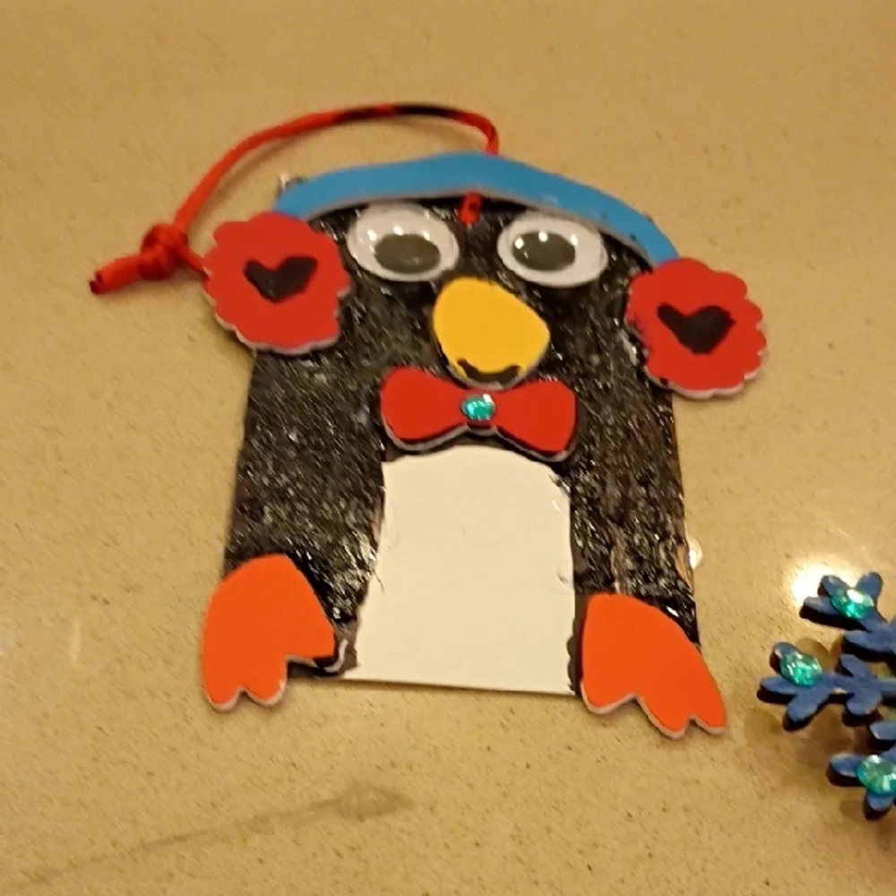 Penguin With A Magnet Snowflake And Heart Face With Wings